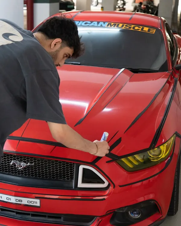 This was such a fun and challenging project. We gave this red Ford Mustang a "cartoon" or "borderlands" effect by hand-painting black comic-style outlines all over the car.