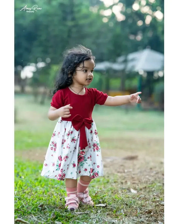 Two-year-old Riona exploring the park during her pre-birthday shoot. I encourage kids to move around and be curious, which allows me to capture natural, unposed photographs like this one.