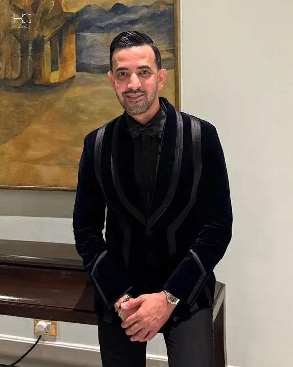 Ali Baldiwala in a custom black velvet tuxedo designed for celebration. The unique lapel design adds a modern, structural element to a classic garment.