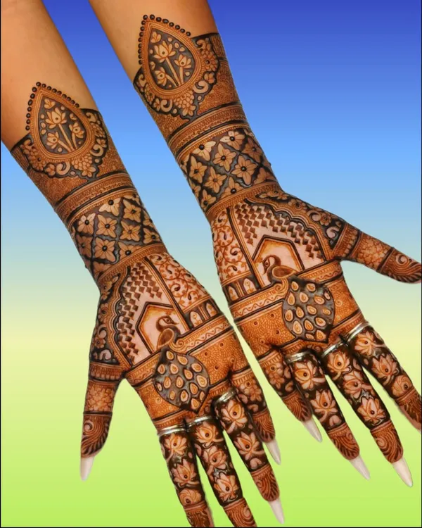 This is the kind of intricate Rajasthani mehandi I love to create. Notice the fine details in the peacocks, the lotus patterns on the fingers, and the clean geometric jaal work. I put a lot of mehnat into making sure every line is perfect for your special occasion.
