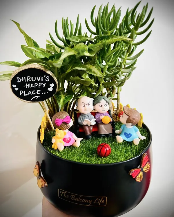 This one is so special to me. It was a gift for a toddler from her grandparents, showing them all together in their happy place. I love creating these little scenes that capture so much love in a beautiful succulent garden.