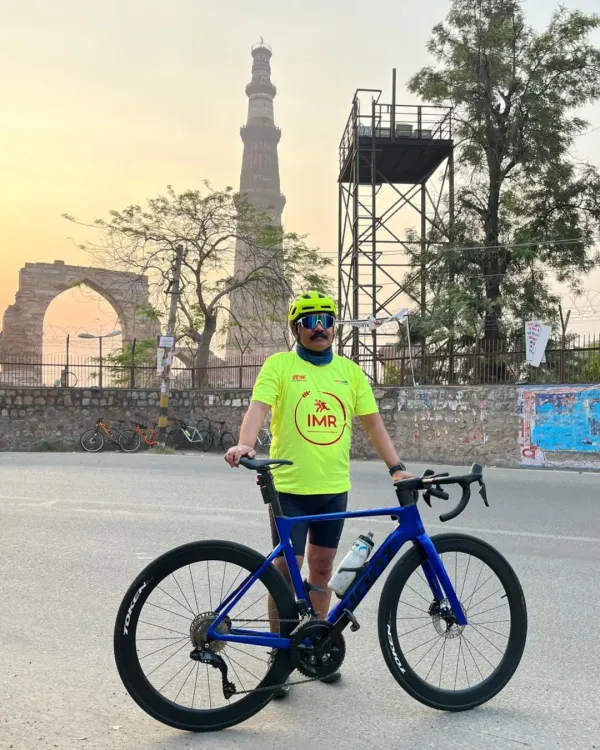 A solo shot with the majestic Qutub Minar at sunrise. Our heritage rides allow you to experience Delhi's history in a completely new light.