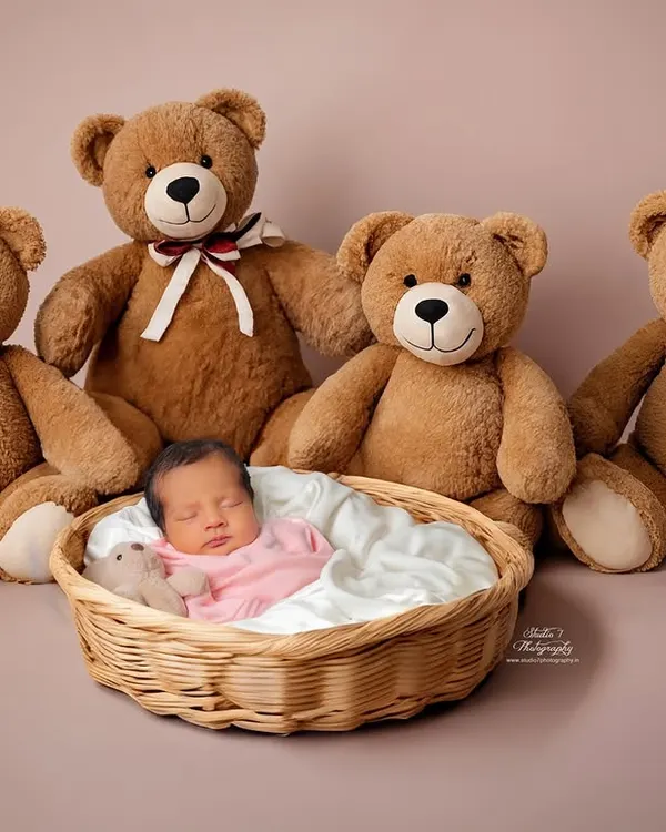 A classic and heartwarming setup for a newborn session. This sweet baby is sleeping soundly in a simple basket, watched over by a family of fluffy teddy bears. It’s a timeless concept that always results in adorable photos.