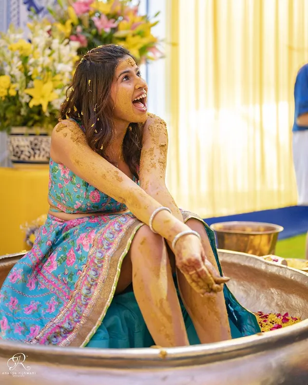 The bride's priceless reaction during her fun-filled Haldi ceremony in Delhi. The joy is just bursting out of this photo.