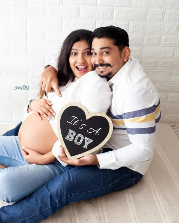 Such a fun and happy announcement! This couple's excitement is contagious, and the "It's a Boy" sign is a perfect prop for sharing their joy.