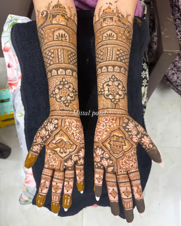 A classic full-arm bridal design featuring palace architecture at the top. The palms are adorned with a beautiful peacock and a personalized initial, blending royal motifs with a personal touch.
