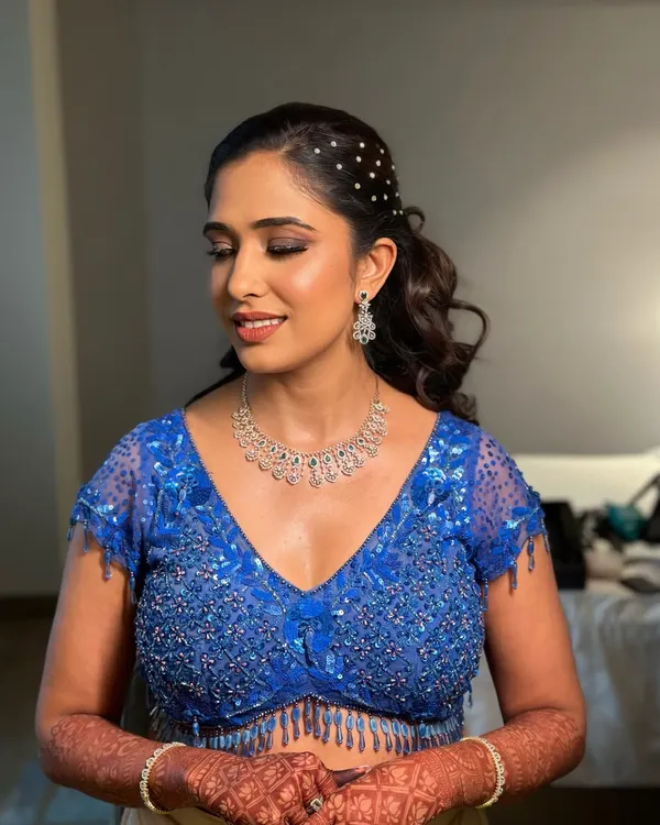 This modern and chic ponytail is adorned with scattered pearls, adding a touch of glamour and sophistication. It's the perfect hairstyle to show off an intricate neckline and statement earrings.