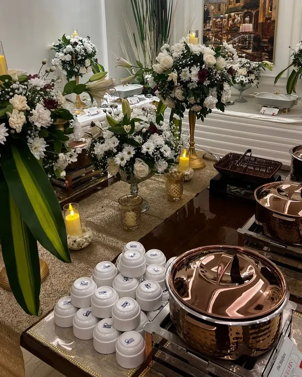 An elegant buffet setup for an intimate gathering at home, featuring my signature copper serveware and beautiful floral arrangements.