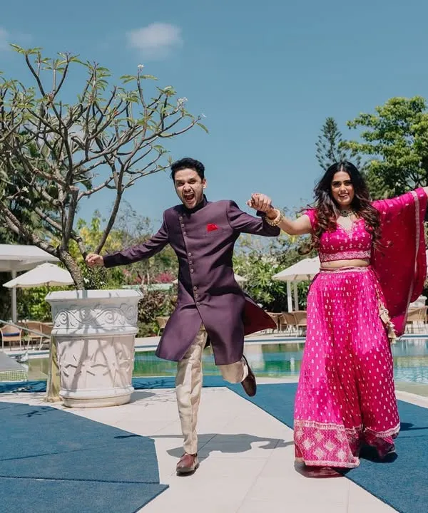 Pure, infectious energy from a couple running by the pool. This shot is all about fun and matching each other's vibe, creating a perfect memory of their engagement celebration.