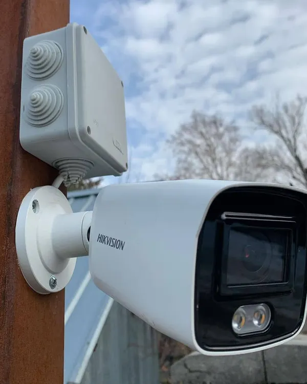A professionally installed Hikvision bullet camera with a weatherproof junction box. This setup protects the connections from rain and dust, ensuring your security system works reliably in any weather.