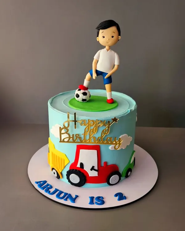 Look at that swag! A cake for Arjun's 2nd birthday, featuring a little boy with a football and his favorite trucks. A perfect cake for a toddler who loves to play.
