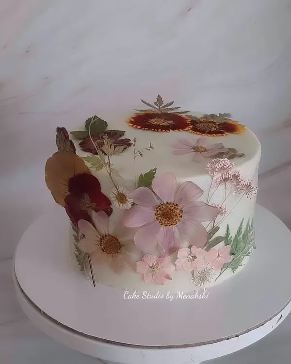 One of my prettiest cakes, adorned completely with hand-pressed, dried natural flowers. Each delicate flower was carefully placed to create this stunning, botanical work of art on a no-fondant cake.