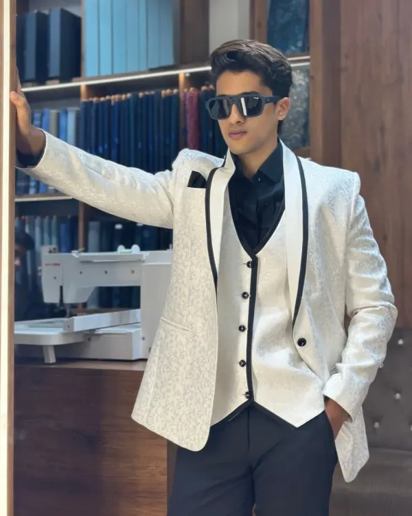 This white textured three piece tuxedo with black satin piping is the definition of modern elegance. It's designed for grooms and guests who want a sharp, sophisticated look for a wedding or reception.
