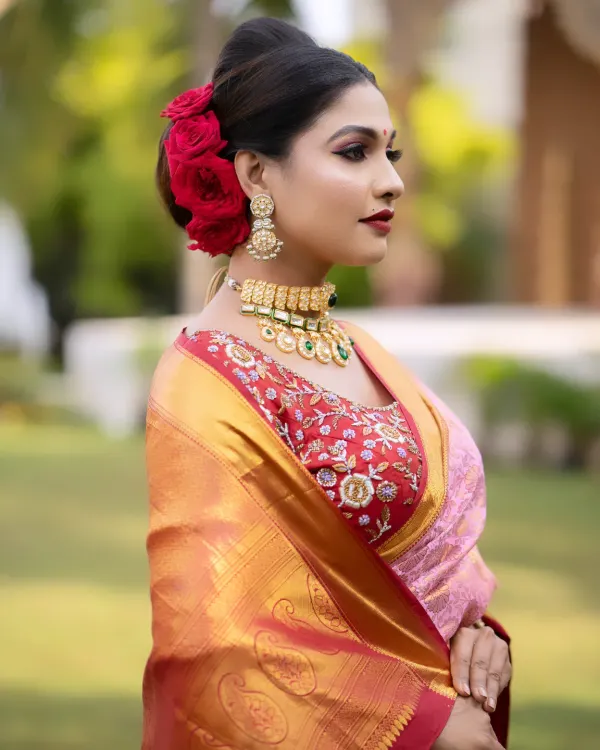 A bride's glow is her best accessory. Here, I've created a classic South Indian bridal look, focusing on radiant skin, defined eyes, and a bold lip, complemented by a traditional floral hair bun that completes the ensemble.