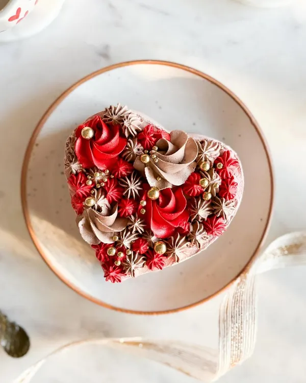 A heart-shaped cake with intricate red and chocolate piping. This is from my Valentine's Day collection, designed to melt hearts.