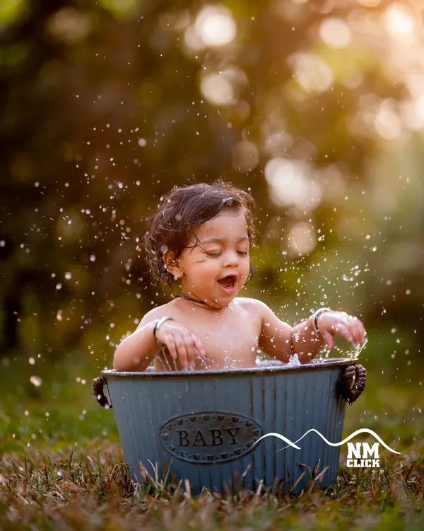 The magic of a golden hour bath session. The warm light and happy splashes combine to create a truly breathtaking and joyful portrait.
