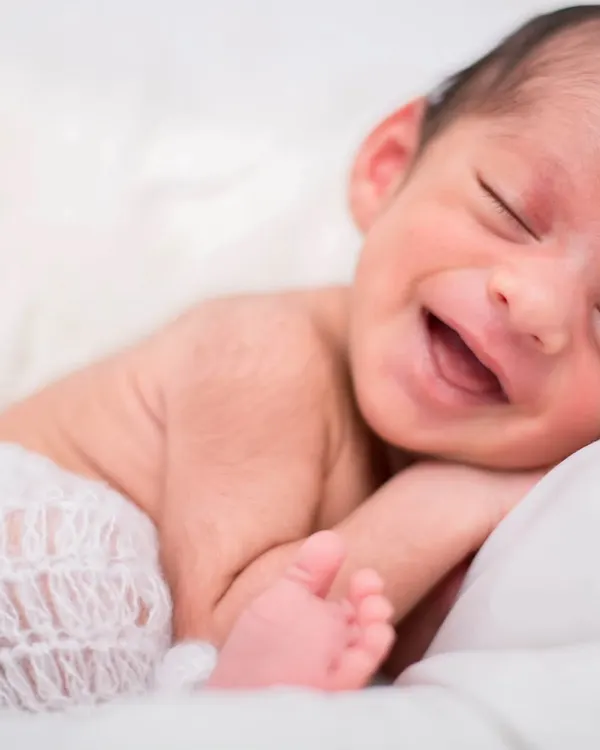 That first, pure smile is one of the most precious things to witness. I focus on creating a calm and comfortable space so we can capture these fleeting, natural moments of newborn joy.