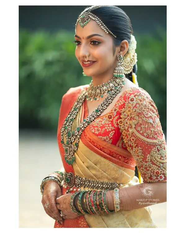 A beautiful side profile of my bride Likitha, showcasing the harmony between her makeup, the intricate embroidery of her blouse, and her stunning emerald and polki jewelry. This is the essence of a complete, regal bridal look.