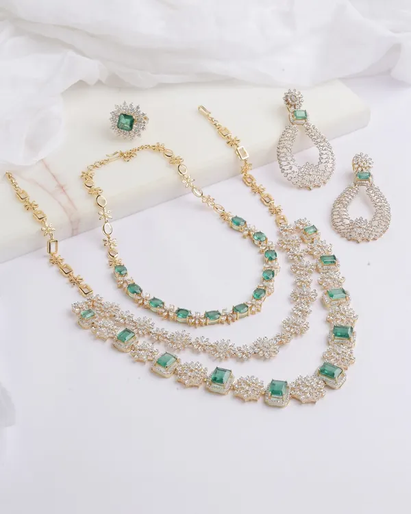 The complete Heera Panna set, a celebration of emeralds and diamonds. This versatile suite includes a double layered, detachable necklace, a magnificent cocktail ring with a 5 carat Ascher cut emerald, and matching teardrop earrings.