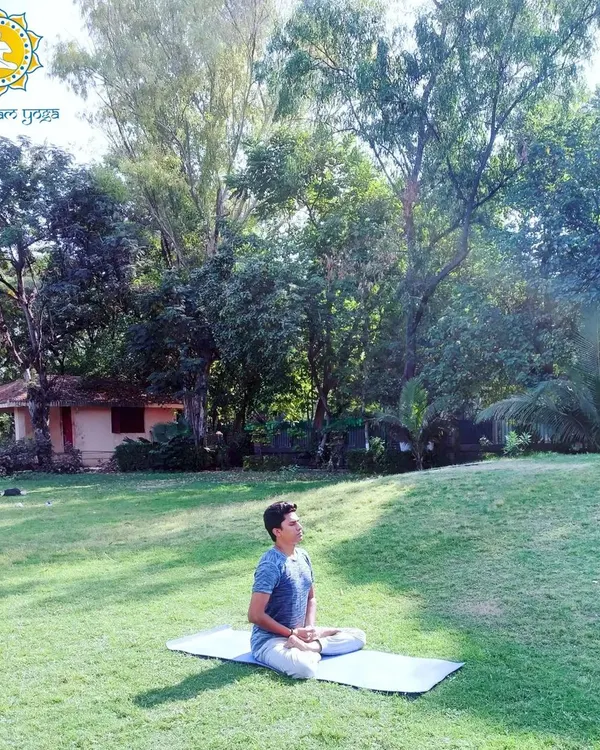 Seated in meditation in a serene, natural environment. A sound mind resides in a sound body, and my practice emphasizes achieving this holistic health through the union of physical postures and mental stillness.