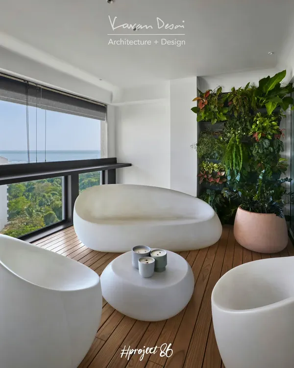 The deck एरिया of Project 86. We created a relaxing outdoor lounge with a vertical garden, wooden floors, and backlit Vondom furniture. It's the perfect spot for a sundowner with a view of the ocean.