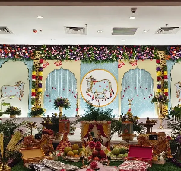 This grand Pichwai-themed stage is one of my signature offerings for traditional ceremonies. I use authentic art panels, lush greenery, and traditional brass lamps to create a divine atmosphere for your family's special day.