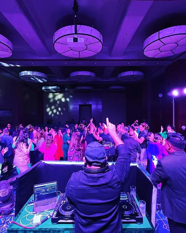 Here I am, commanding the dance floor at a large corporate event at the Taj Chia Kutir. My focus is always on reading the crowd and playing the right track at the right time to keep the energy high all night.