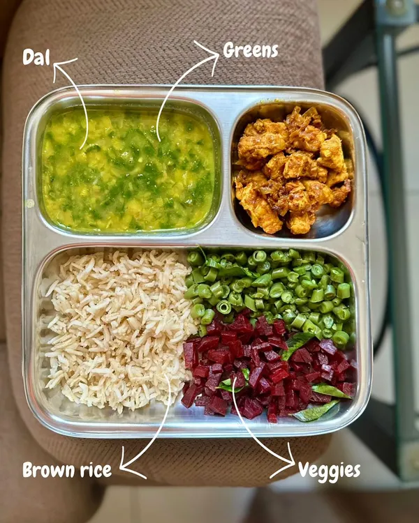 I used to hate vegetables as a child, but now they are a core part of my diet. This plate with brown rice, dal, greens, and veggies shows how my understanding of balanced meals has evolved. Indian food offers incredible variety for a plant-based diet.