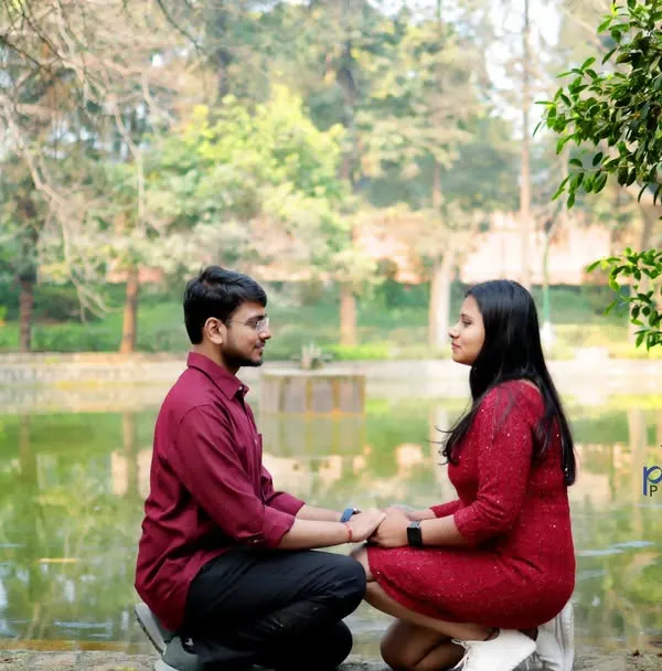 A candid shot of the couple facing each other by the lake at Lodhi Garden. This natural, unposed moment captures their genuine connection and the serene park atmosphere.