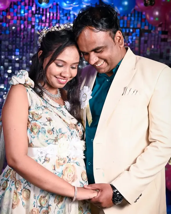 A sweet, candid moment between the expecting couple at their baby shower. Their happy smiles and gentle hold show the excitement and love that filled the room during their celebration.
