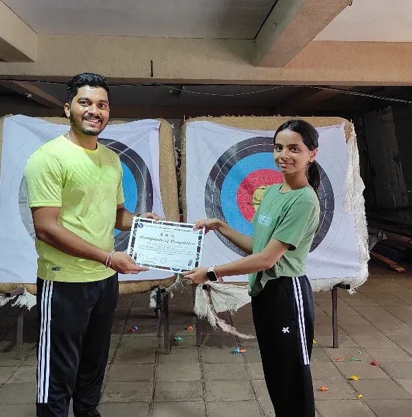 Another happy student from our July Basic Archery Course receiving her certificate. It's a proud moment for both the archer and the coach.