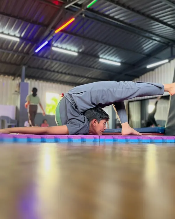 Defying gravity and expectations. This incredible pose showcases the amazing strength and flexibility of a true contortionist. We help you reach for the extraordinary.