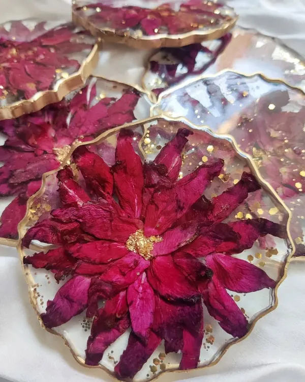 Capturing everlasting love in a set of custom floral coasters. These pieces are made with real preserved flowers and edged with gold, making them a beautiful and functional addition to any home.