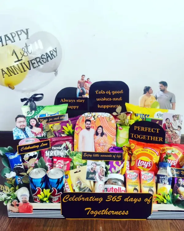 This first anniversary hamper is a perfect example of how I bring your story to life. It's packed with the couple's favorite snacks, drinks, and decorated with personal photos and custom messages to celebrate 365 days of togetherness.