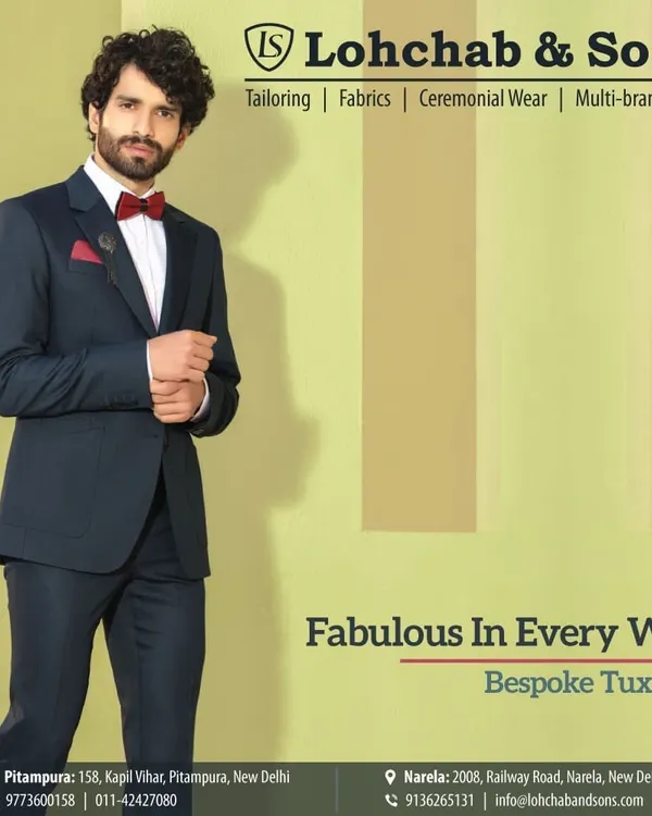 Our bespoke tuxedos are designed to make you look and feel fabulous. This model wears a deep navy tuxedo with a classic peak lapel, paired with a striking red bow tie for a touch of personality.
