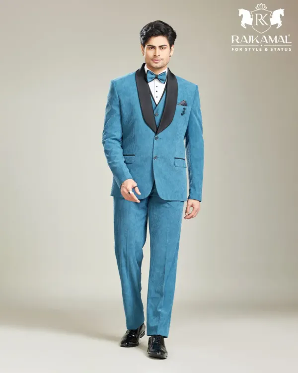 A full view of a modern three-piece suit in a vibrant blue. The black shawl collar adds a touch of classic tuxedo styling, making it a versatile choice for cocktail parties and receptions.