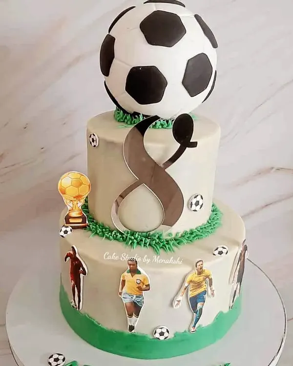 I love this stunning two-tier football themed cake, made with zero fondant. It's perfect for a big celebration, featuring a giant football topper and famous players.
