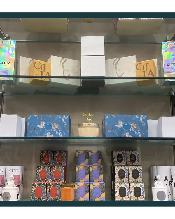 I offer over 30 varieties of beautiful, premium scented candles at my studio. This shelf displays just a fraction of the collection available to add a sensory touch to your hamper.