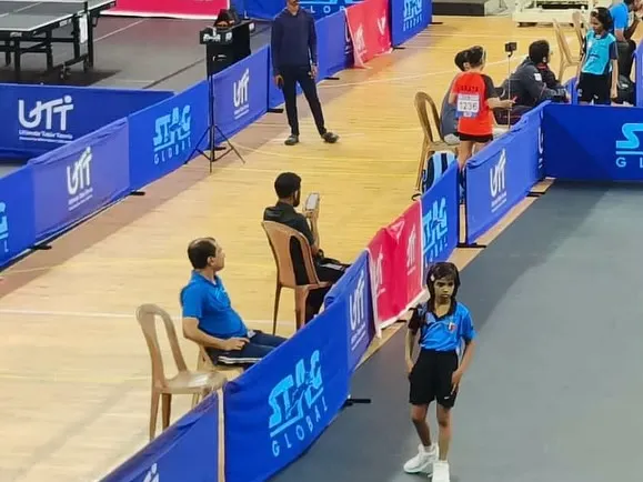 Coaching extends beyond the training hall. Here I am watching our player Ghanavi during a crucial match, providing strategic guidance from the sidelines.