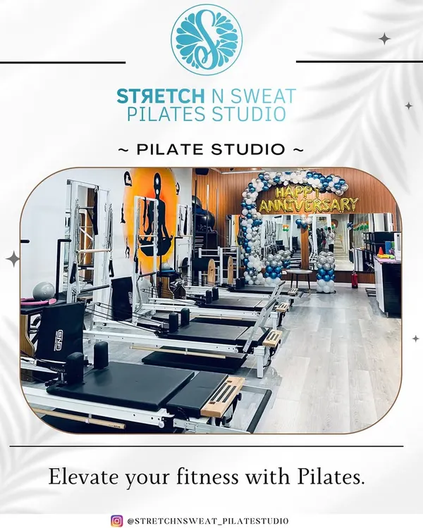 A wide view of our clean and modern studio, fully equipped with reformers and ready for our anniversary celebration. This is where you'll elevate your fitness.