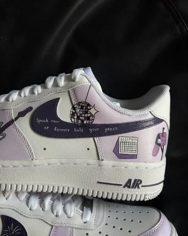 A close-up of the "Speak Now" Taylor Swift custom Nike Air Force 1, featuring lyrics and a disco ball design.