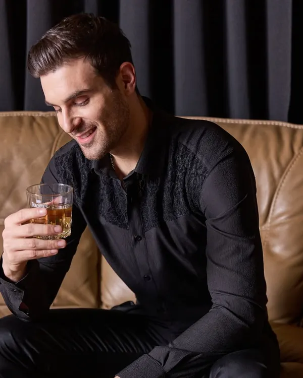 This is my idea of a perfect party shirt. A classic black shirt elevated with subtle, tonal lace embroidery on the shoulders. It's the right combination of fashion, glitz, and understated elegance.