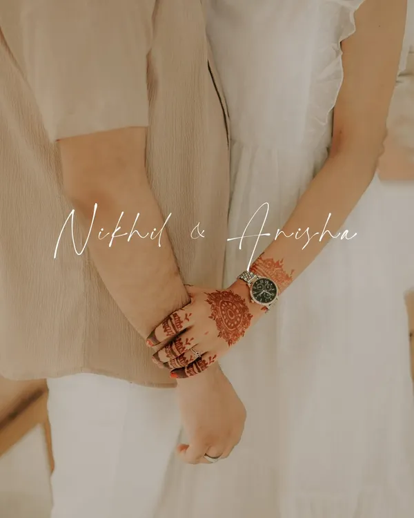 A simple and romantic pre wedding shot, focusing on the couple holding hands. The bride's mehndi adds a touch of tradition to this modern, poetic frame.