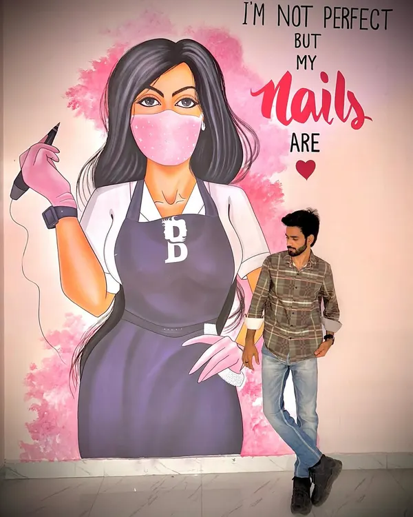 This is me at my studio. The mural behind me says it all: I'm not perfect, but my nails are. I bring that passion for perfection to every class I teach.