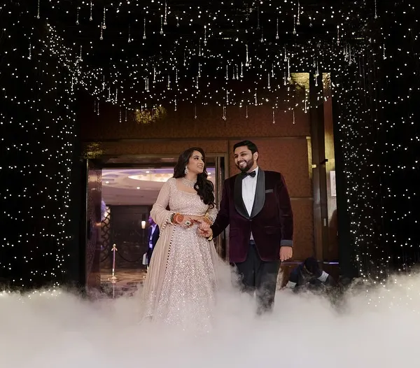 A grand entrance for a grand night. I designed this starlit tunnel with low-lying fog for the couple's Sangeet entry at the Taj Palace, creating a moment of pure cinematic magic.