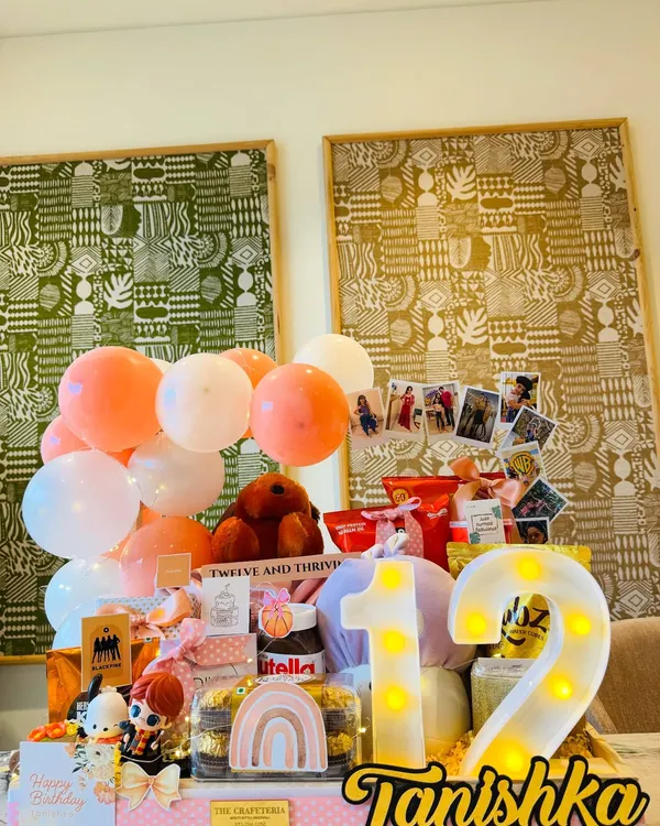 A dreamy peach-themed hamper for a 12th birthday. We included a light-up number '12', a personalized nameplate for Tanishka, and a collection of her favorite things, from Nutella to cute figurines.