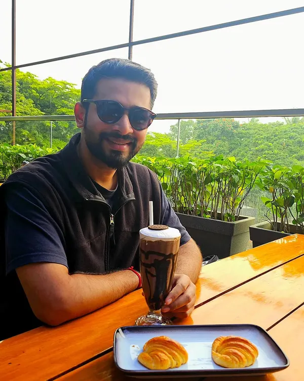 Taking a break at a cafe in Kolhapur. I enjoy exploring new places and food, and this relaxed photo captures a moment of simple enjoyment.