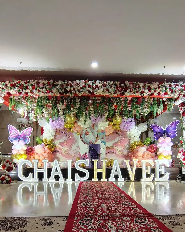 This grand butterfly-themed stage was set up in a large banquet hall, but I can adapt similar large-scale decorations for outdoor marquee events.