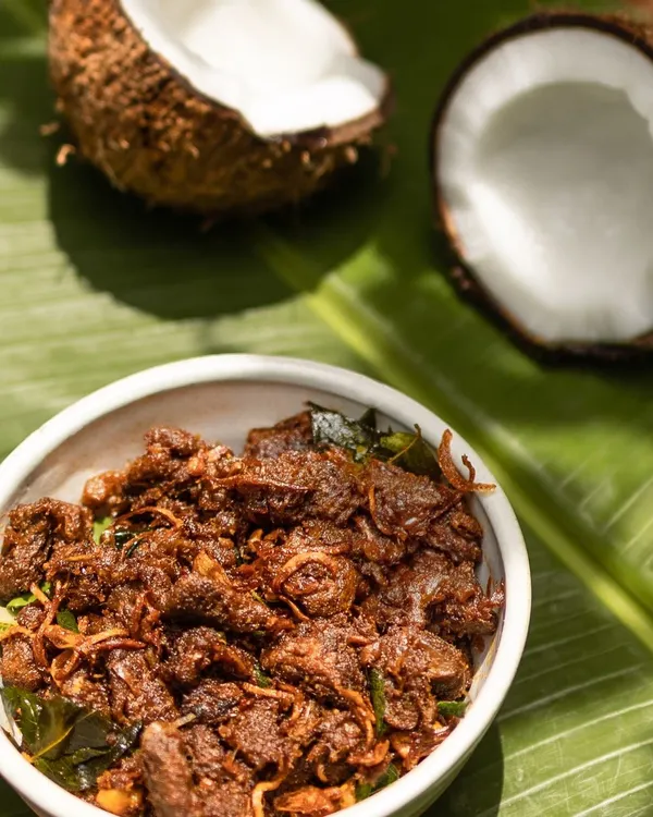 This is my signature Beef Ullarthu, a staple in any Syrian Christian home. I slow roast beef in a spicy, aromatic masala with coconut chunks and curry leaves until it's incredibly flavourful. It's a fantastic starter or side dish for any meal.