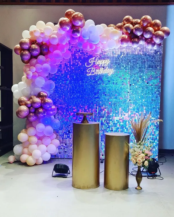 A popular choice for milestone birthdays and elegant events. This setup features a dazzling sequin wall, a custom neon sign, and a beautiful organic balloon garland in rose gold and white.